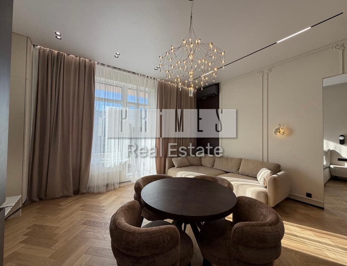 Living room with a chandelier and tall windows
